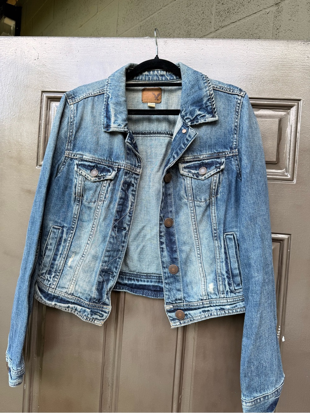 American Eagle Outfitters light blue denim jacket with brown leather label